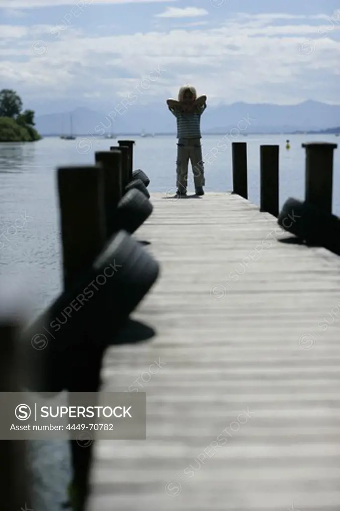 Boy on jetty, Roseninsel Island, Possenhofen, Lake Starnberg, Bavaria, Germany
