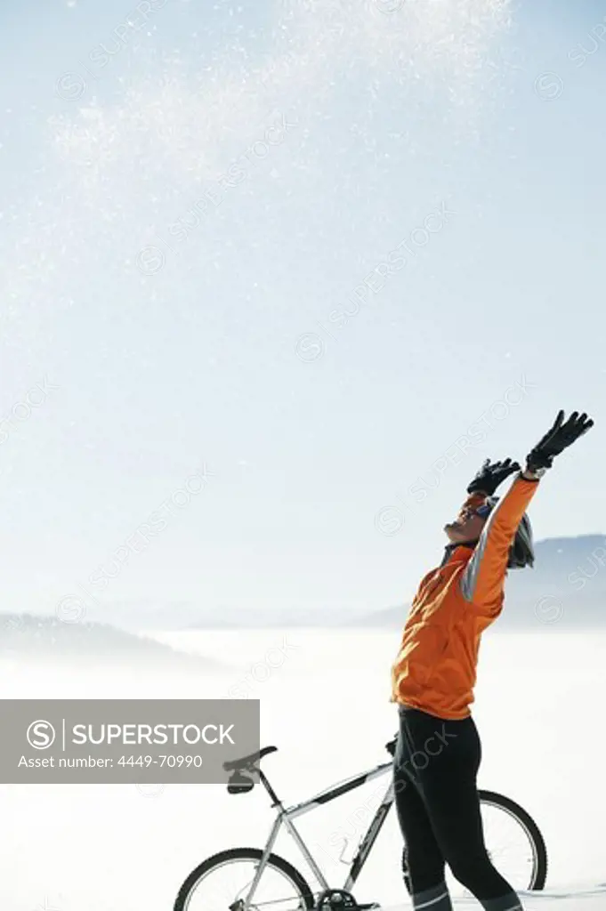 Mountain biker throwing snow up in the air, Styria, Austria