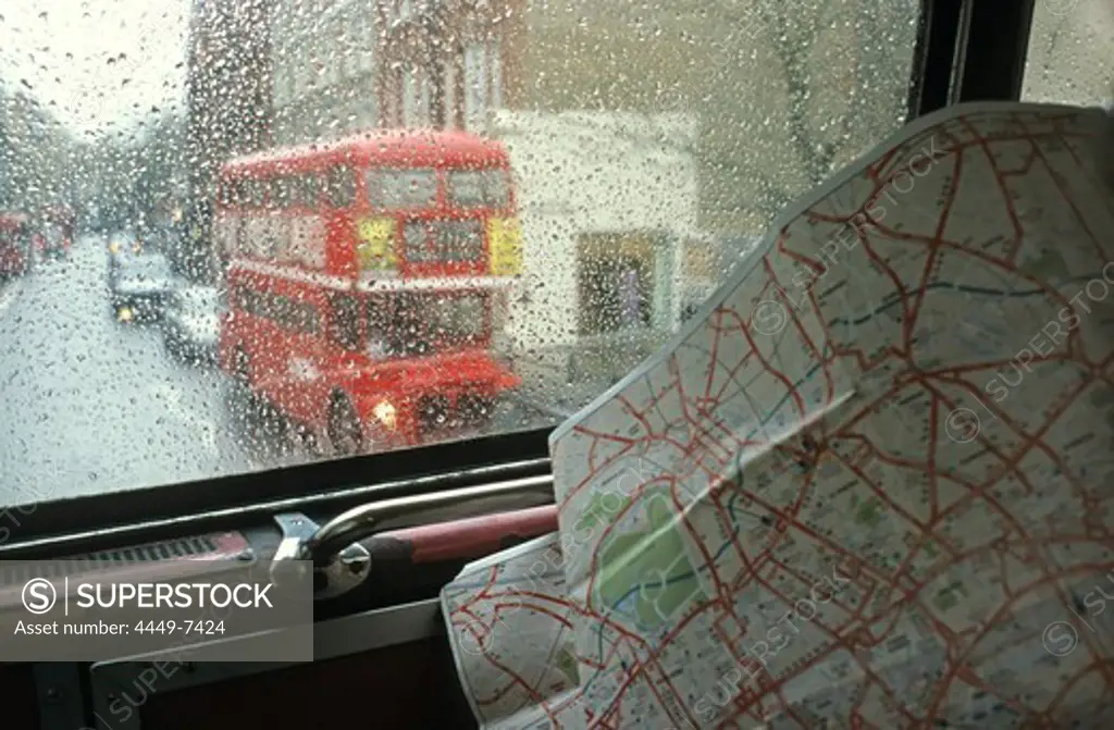 view through rainy bus window with city map, London, England