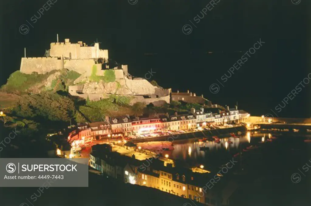 The illuminated Orgeuil Castle above the harbour of Gorey, Jersey, Channel Islands, United Kingdom