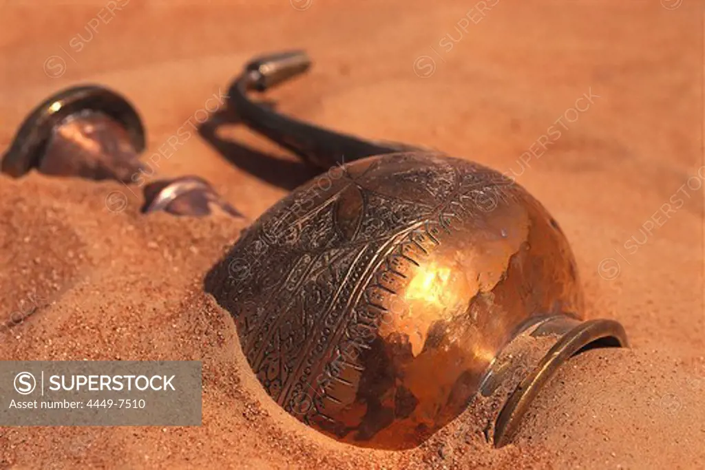 Copper can lying in the sand of the desert, Dubai, United Arab Emirates