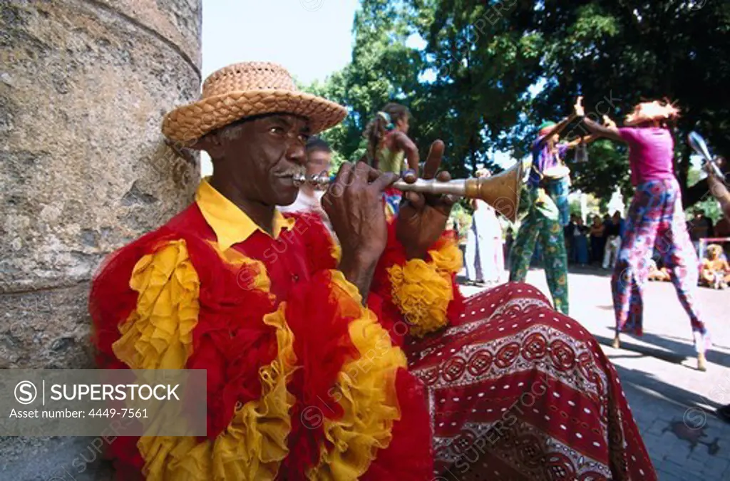 Street musician in the carneval costume playing wind instrument, Havanna, Cuba, Greater Antilles, Antilles, Carribean, Central America, North America, America