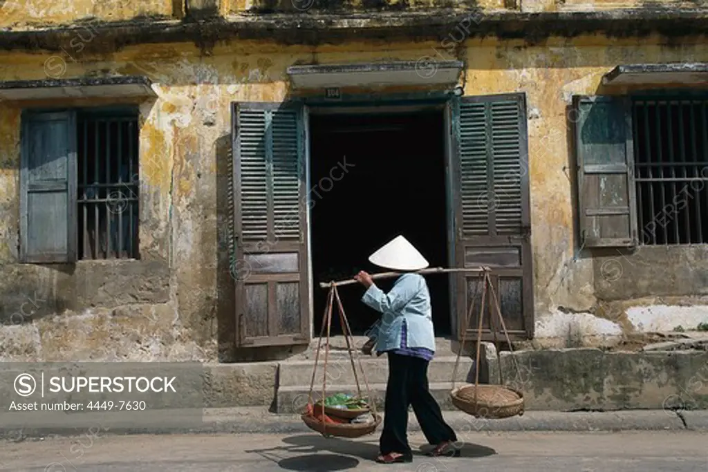 Woman is carrying baskets in Da Nang, Vietnam