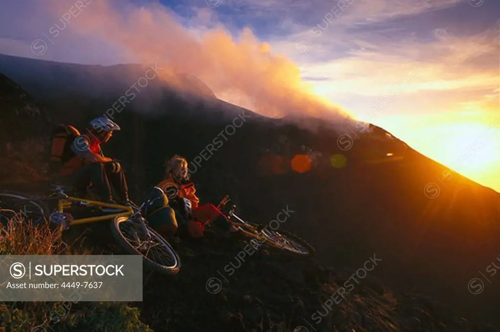 Mountain bikers on Vulcano island at sunset, Aeolian Islands, Sicily, Italy, Europe