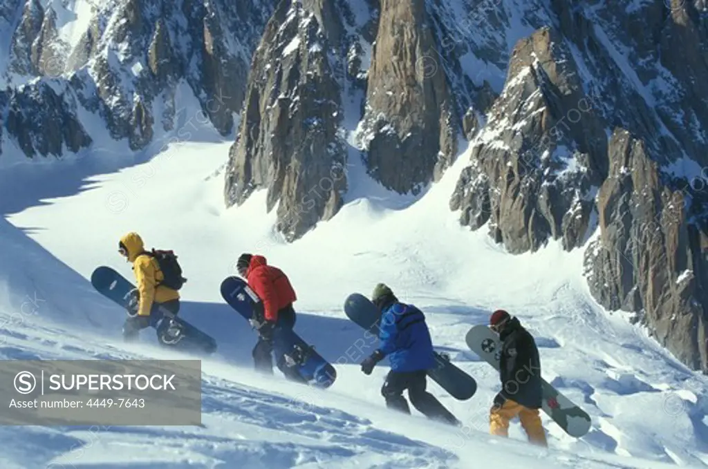 Snowboarder ascending, high mountains, Italy