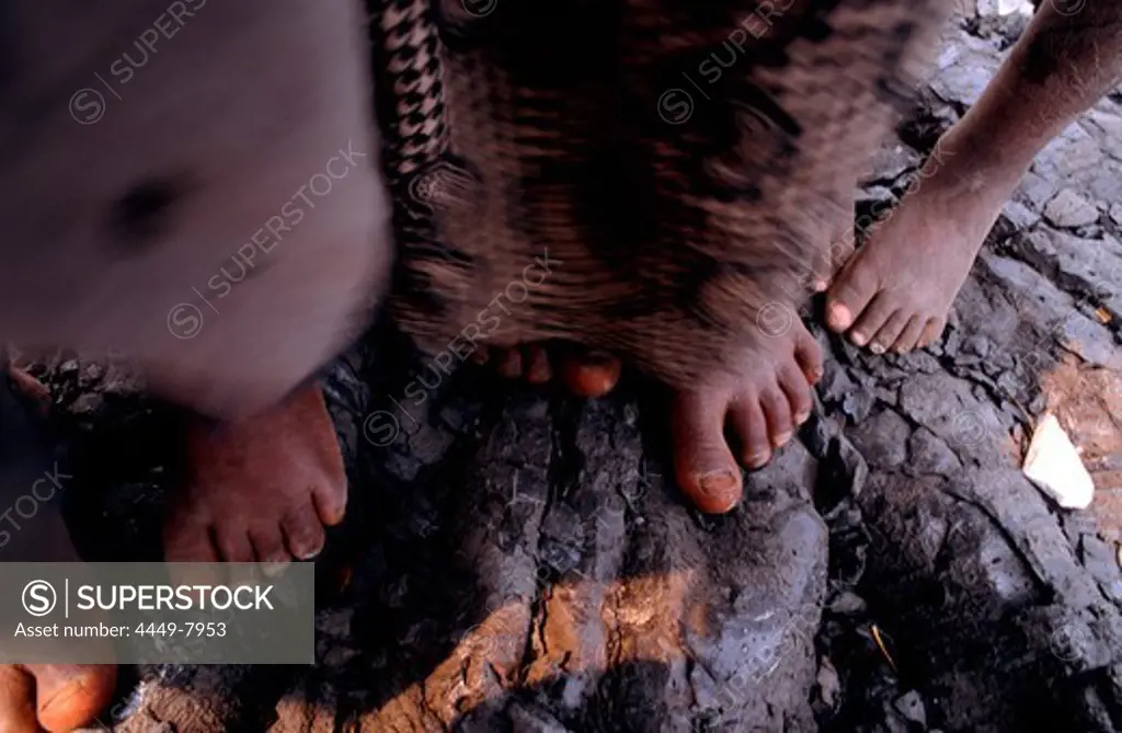 Children's bare feet standing on solidified lava, Goma, Congo, Africa