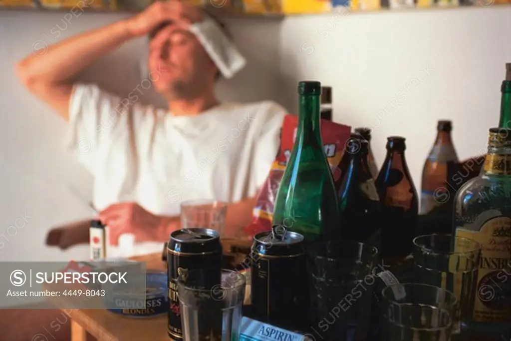 Young man having hangover after drinking alcohol