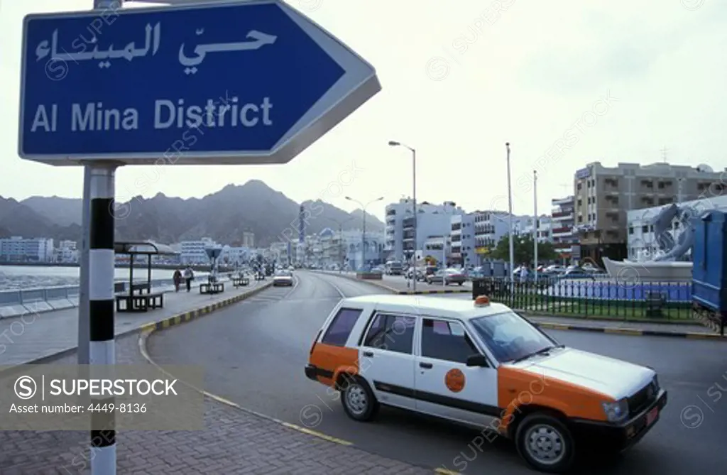 Street sign and taxi in front of the houses of Muscat, Oman, Middle East, Asia