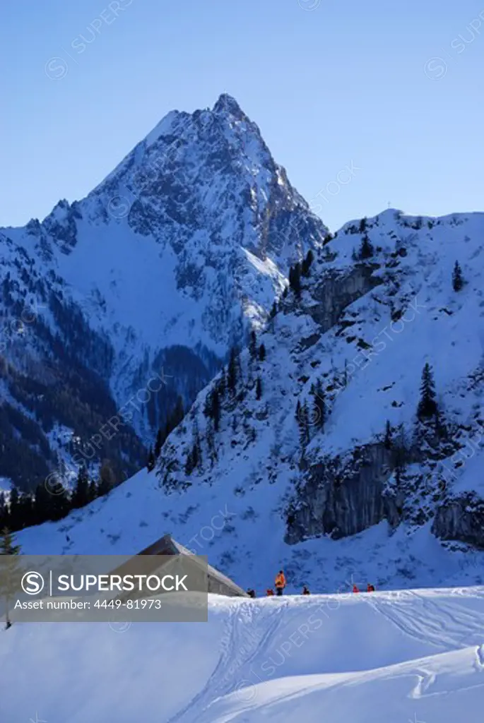 Group of backcountry skiers in front of alpine hut, Grosser Rettenstein in background, Brechhorn, Kitzbuehel Alps, Tyrol, Austria