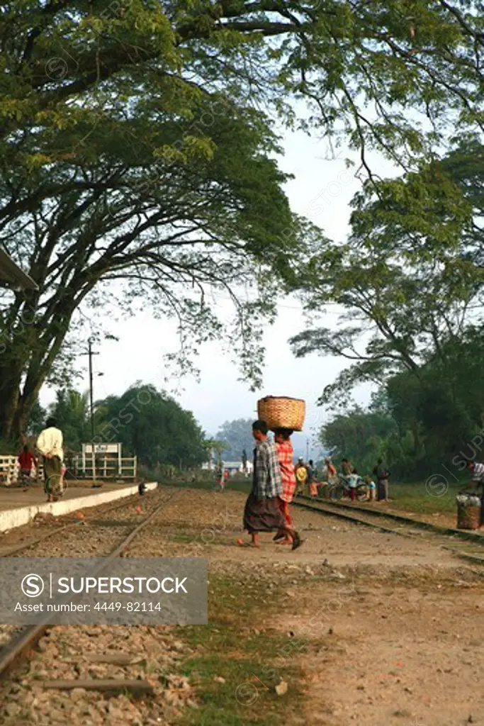 Women carrying a basket over the tracks to the station, Hispaw, Shan State, Myanmar, Burma, Asia