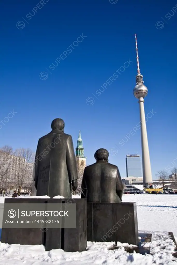Snow landscape at Marx and Engels sculpture, background Alex, Berlin center