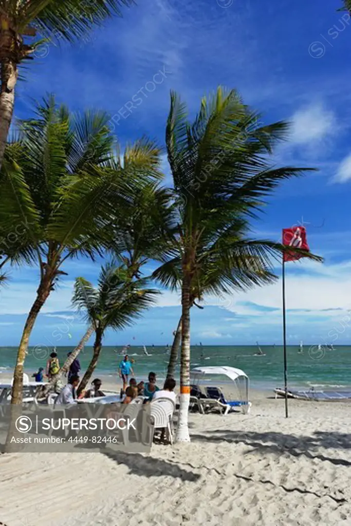 Vacationers at Playa El Yaque, windsurfers in background, Playa El Yaque, Isla Margarita, Nueva Esparta, Venezuela