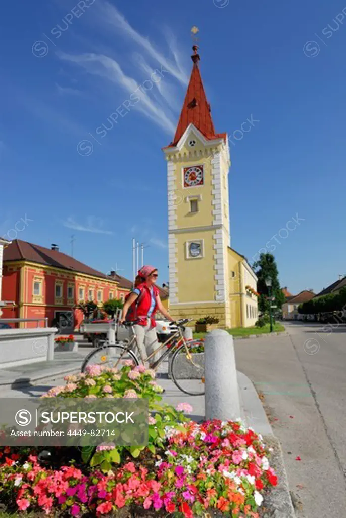 Woman with bicycle near a church, Wallsee-Sindelburg, Mostviertel, Lower Austria, Austria