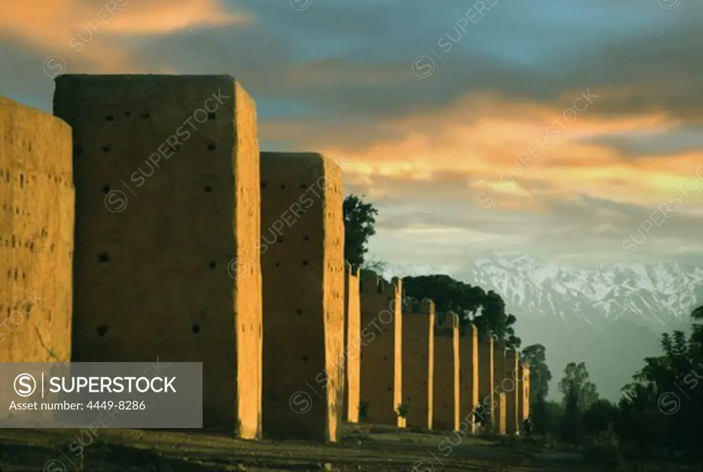 City wall in the evening light and High Atlas, Marrakech, Morocco, Africa