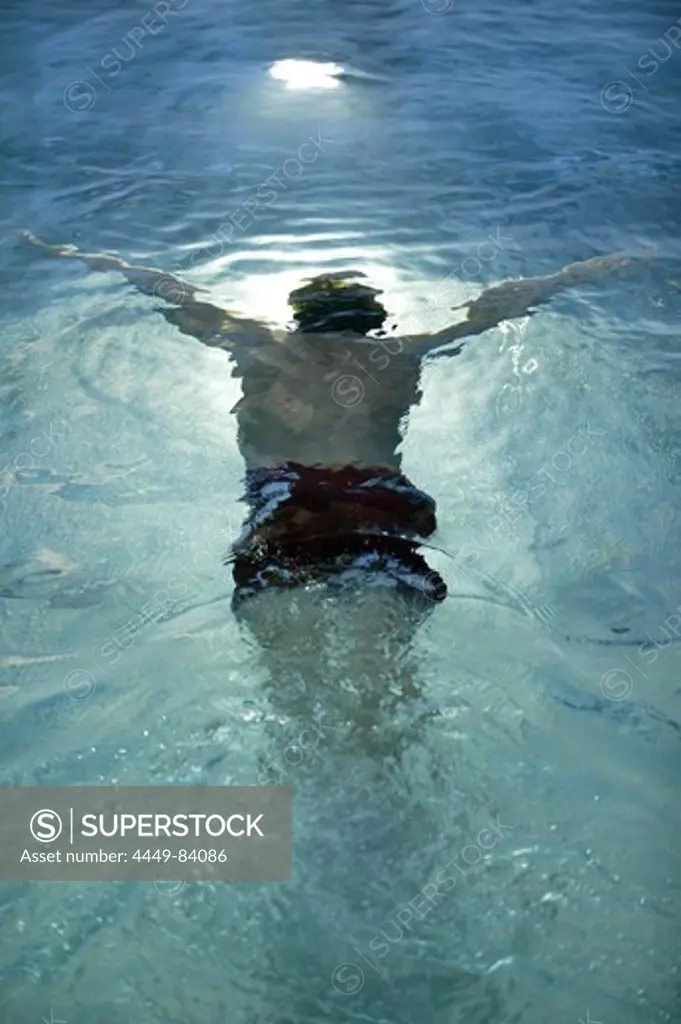 Swimmer swimming under water in an indoor swimming pool, Sport