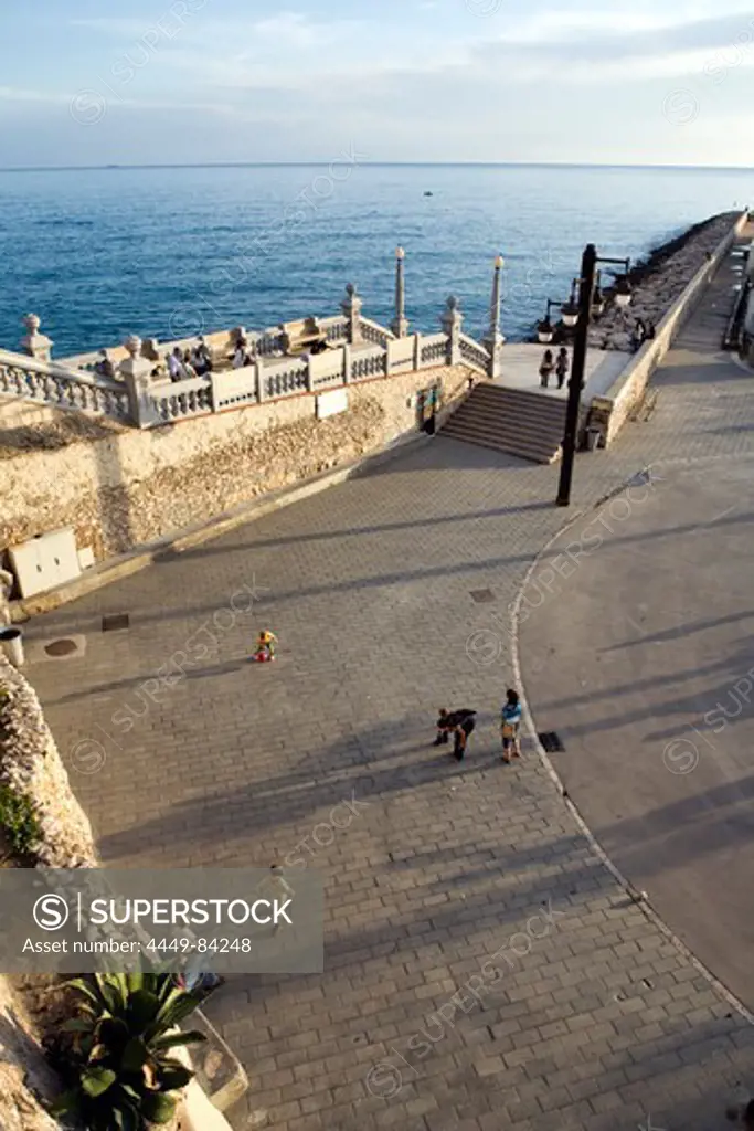 View at the ocean and people on the seaside promenade, Sitges, Catalonia, Spain, Europe