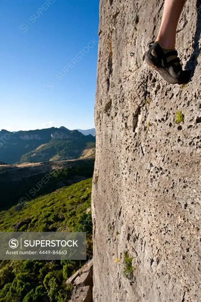 Foot of a climber at a limestone rock face in the sunlight, Jerzu, Sardinia, Italy, Europe