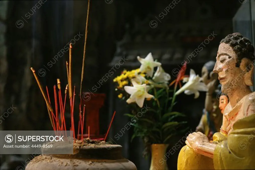 Figure and incense sticks at cave temple at Marble Mountains, Da Nang, Vietnam, Asia