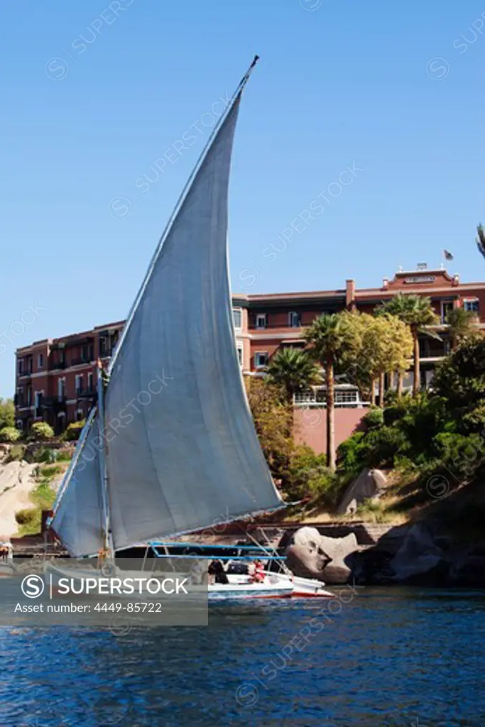 Felucca on the river Nile, the Old Cataract Hotel in the background, Aswan, Egypt, Africa