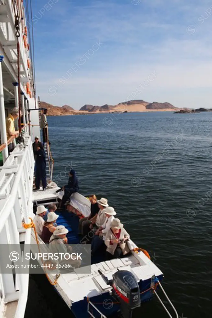 Passengers of cruise ship Prince Abbas in a motor boat, Lake Nasser, Egypt, Africa