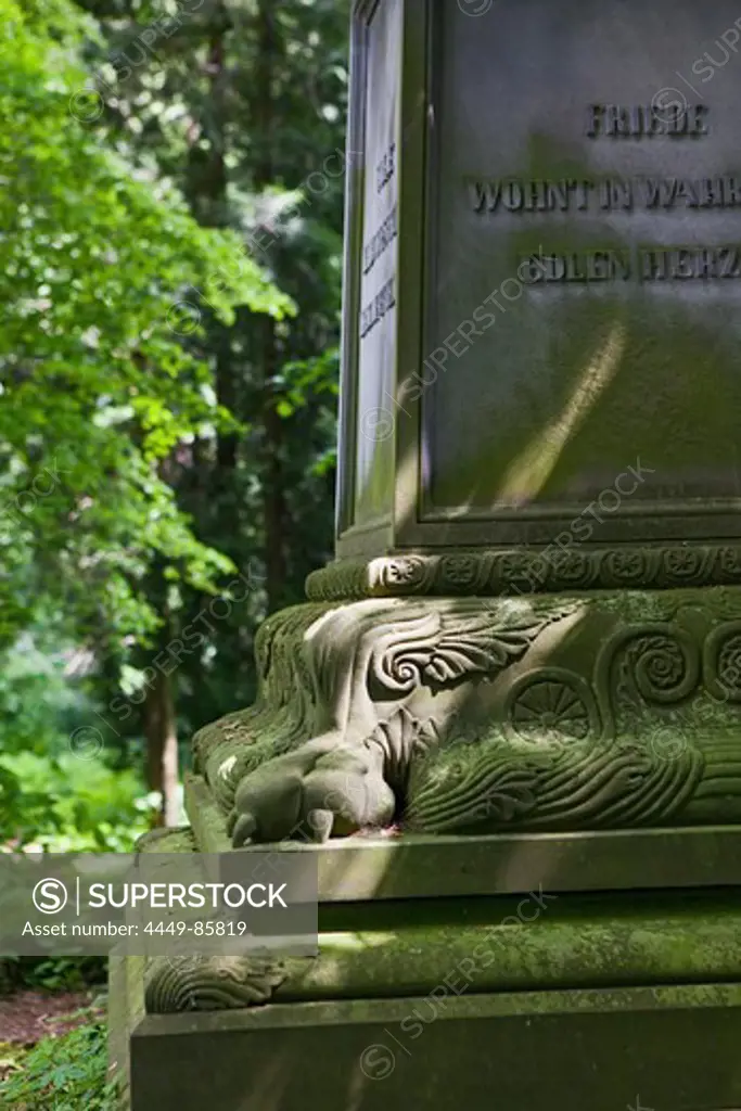 Ornamental gravestone amongst old trees in Wrisberg Garden, Wrisbergholzen, Lower Saxony, Germany