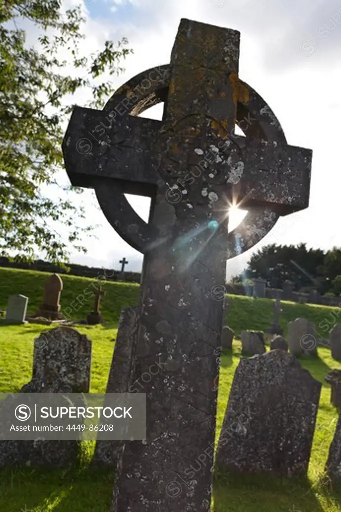 Celtic cross and gravestones in the cemetery of the St. Canice's Cathedral, Kilkenny, County Kilkenny, Ireland