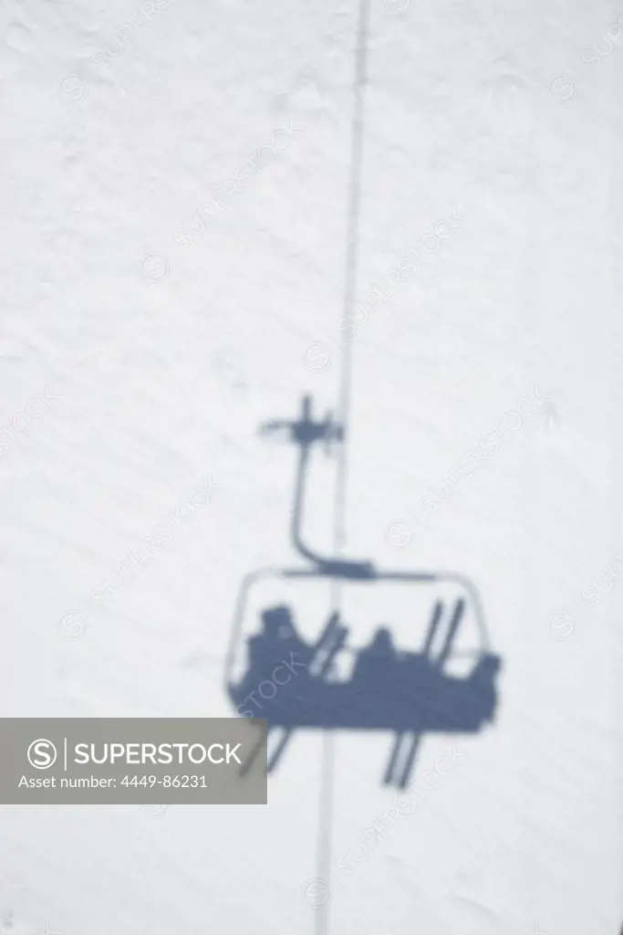 Shadow of chair lift with skiers, Disentis, Oberalp pass, Canton of Grisons, Switzerland