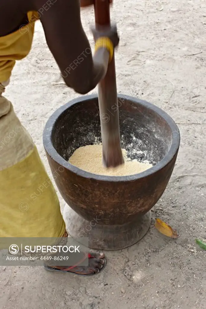 Woman mashes corn in a wooden mortar, Bougouni, Mali, Africa