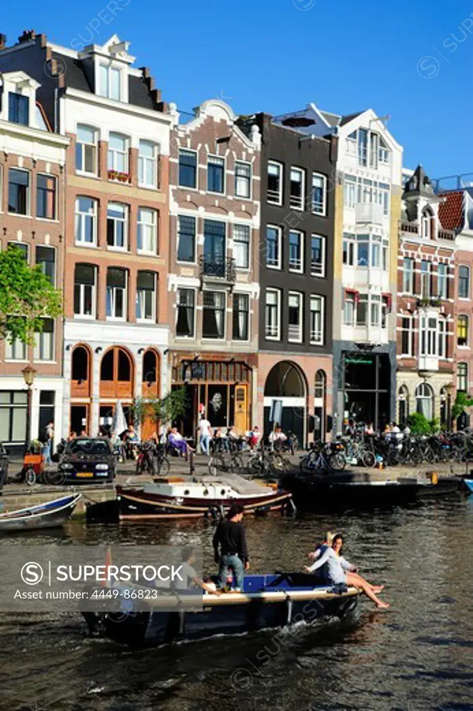 Residential houses and boat on the Prinsengracht canal, Amsterdam, the Netherlands, Europe