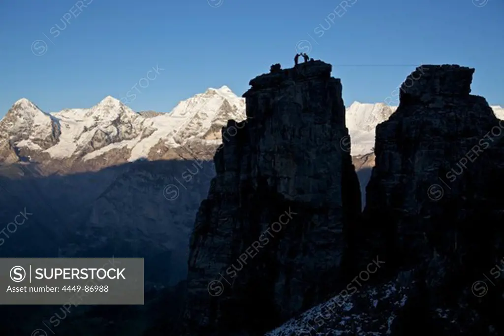 Two men congratulating each other on a rock after walking a highline, Schilthorn, Bernese Oberland, Canton of Bern, Switzerland