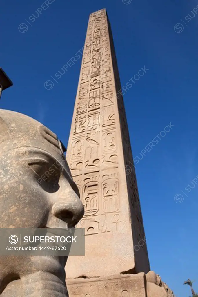 Obelisk and colossal statue of Ramesses II in the entrance area of Luxor Temple, Luxor, Egypt, Africa