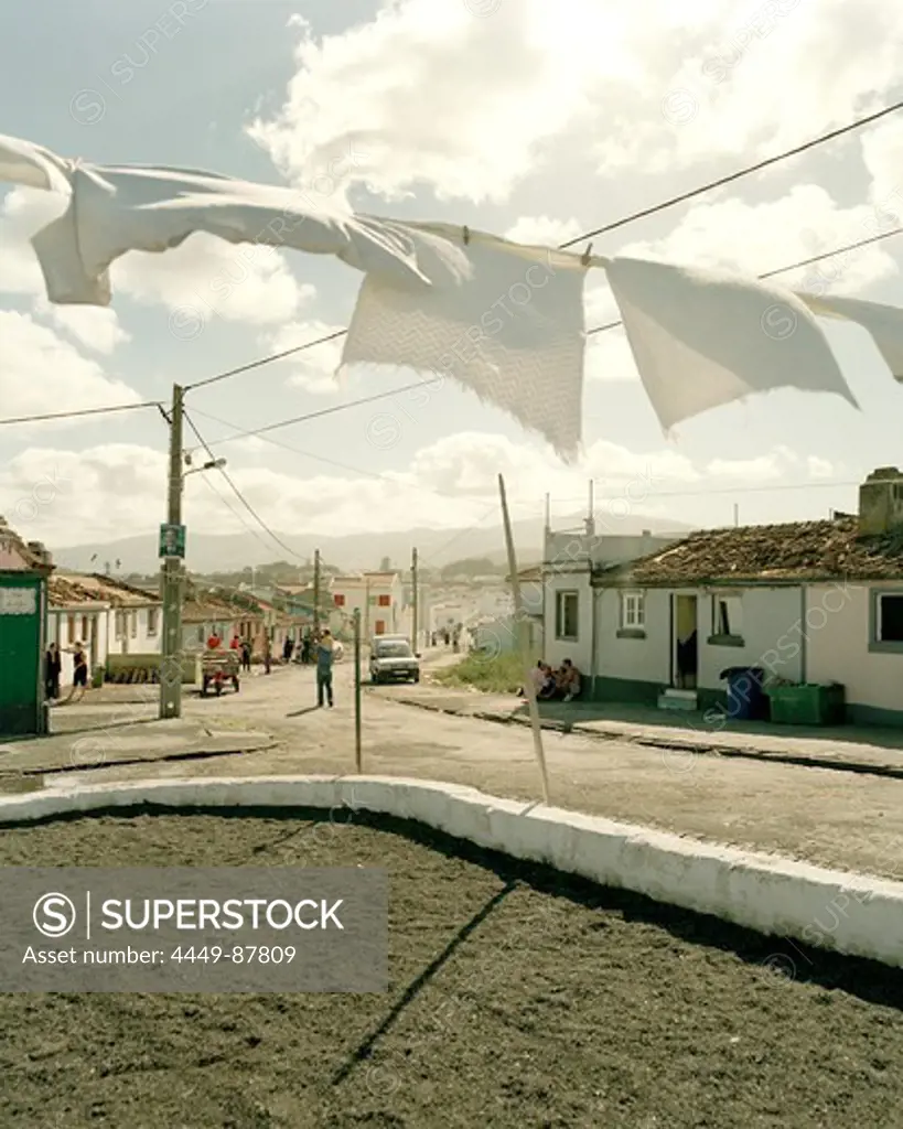 Clothesline in the wind in front of fishermen's houses, coastal town Rabo de Peixe, Sao Miguel island, Azores, Portugal