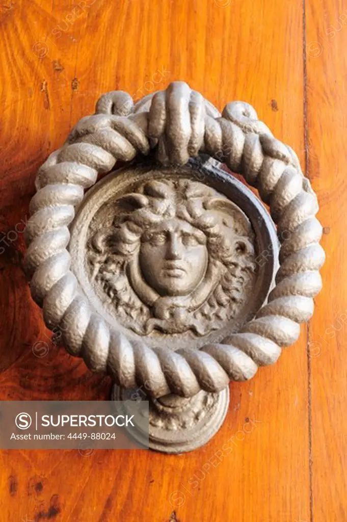 Door knocker in the shape of a face, Montepulciano, Tuscany, Italy