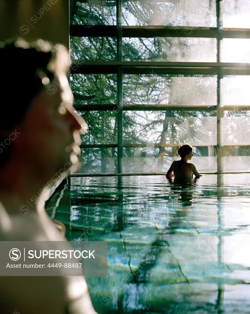 Couple bathing in indoor pool, Vigilius Mountain Resort, Vigiljoch, Lana, Trentino-Alto Adige/Suedtirol, Italy