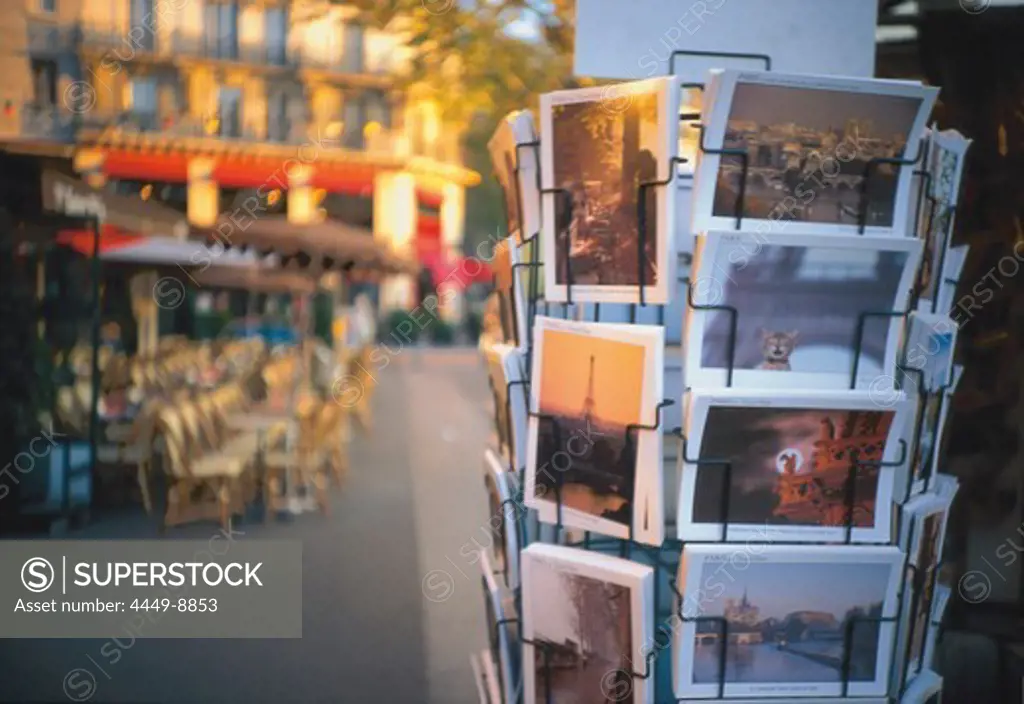 Stand full of postcards, cafe in the background, Place de la Bastille, Paris, France