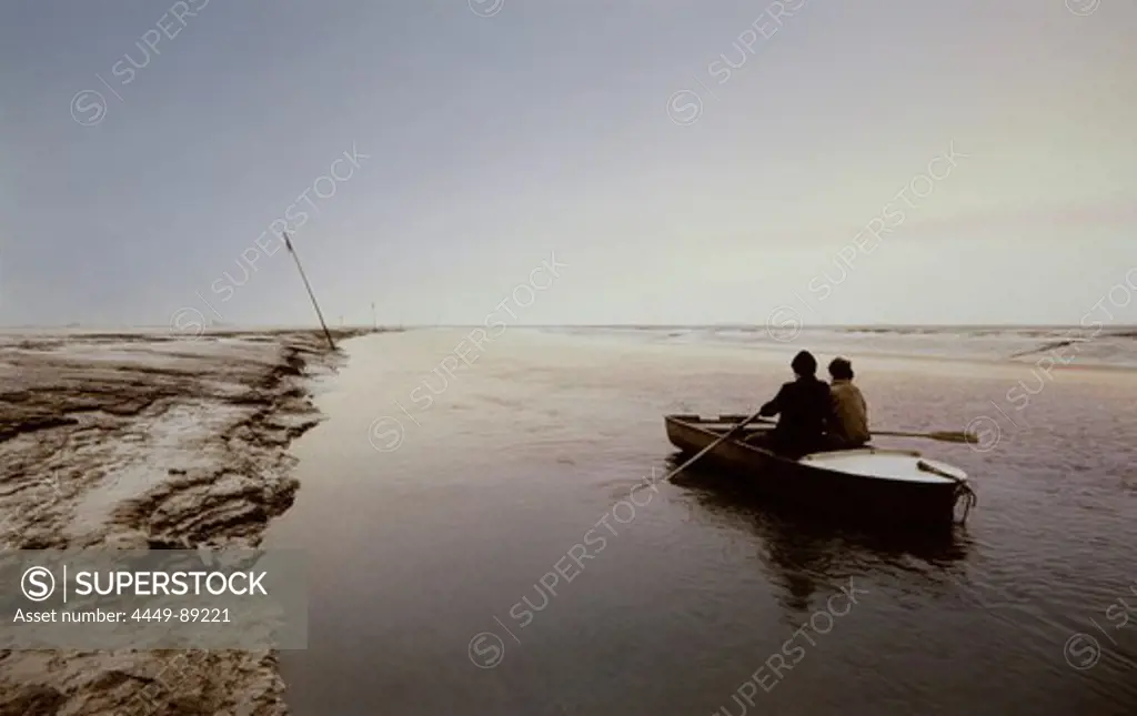 Two men in a rowboat in a tidal creek, East Frisian Wadden Sea, East Friesland, North Sea, Lower Saxony, Germany, Europe