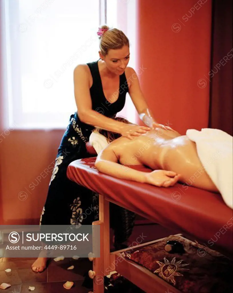 Woman enjoying traditional Hawaiian massage Lomi Lomi Nui in a spa resort, Travemuende, Luebeck, Schleswig-Holstein, Germany
