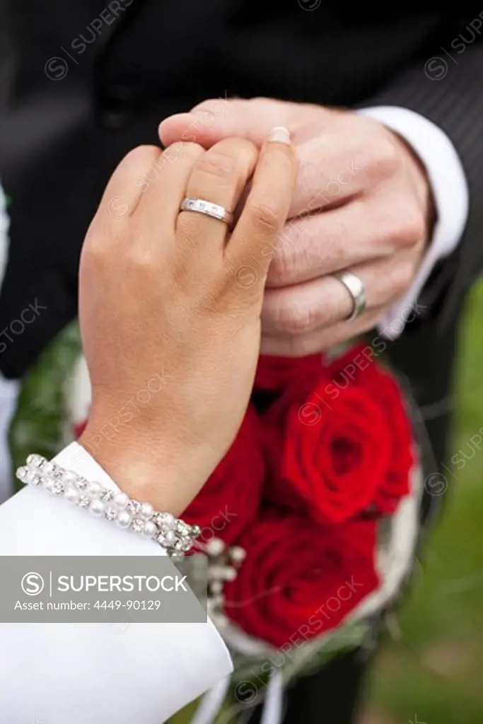 Man and woman showing their wedding rings, Leipzig, Saxony, Germany