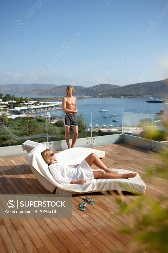 Guests sunbathing on the pool deck, Elounda Beach Resort, Elounda, Crete, Greece