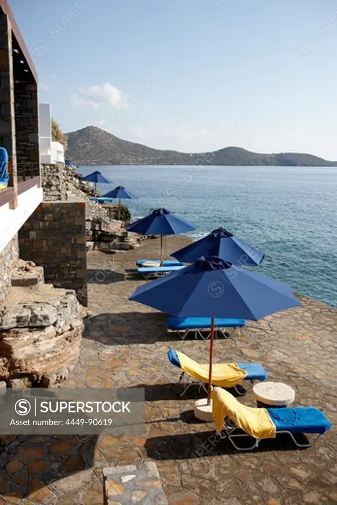 Sunshades and deck chairs at the seasite, Elounda, Agios Nikolaos, Crete, Greece