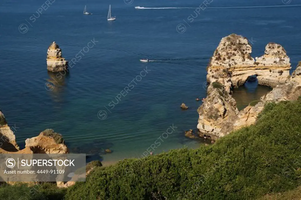 Rock formations and boats, Praio do Camilo, Ponta da Piedade, near Lagos, Algarve, Portugal, Europe