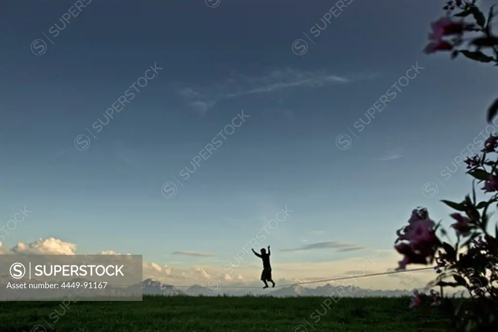 Young man balancing on a longline, Auerberg, Bavaria, Germany, Europe