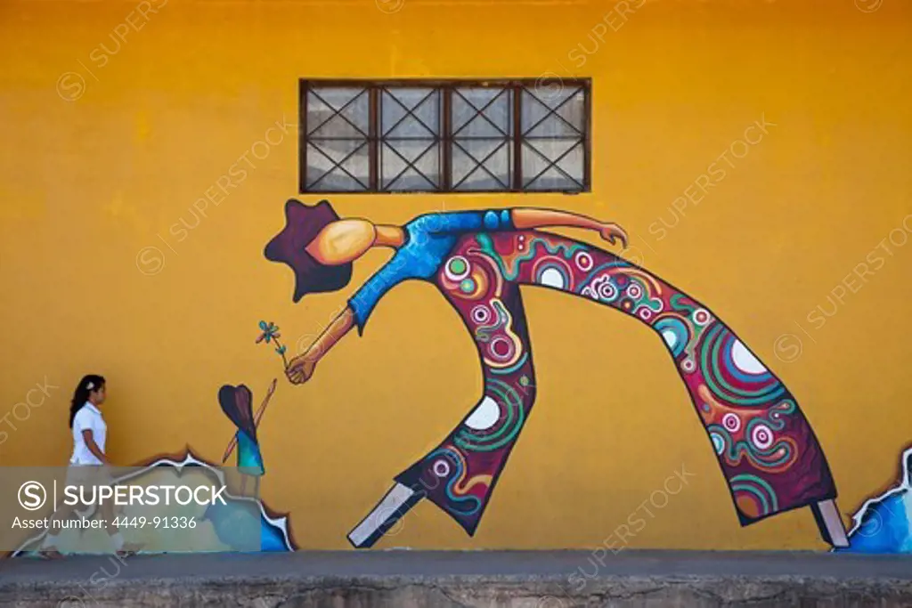 School girl walks in front of mural, Puntarenas, Costa Rica, Central America
