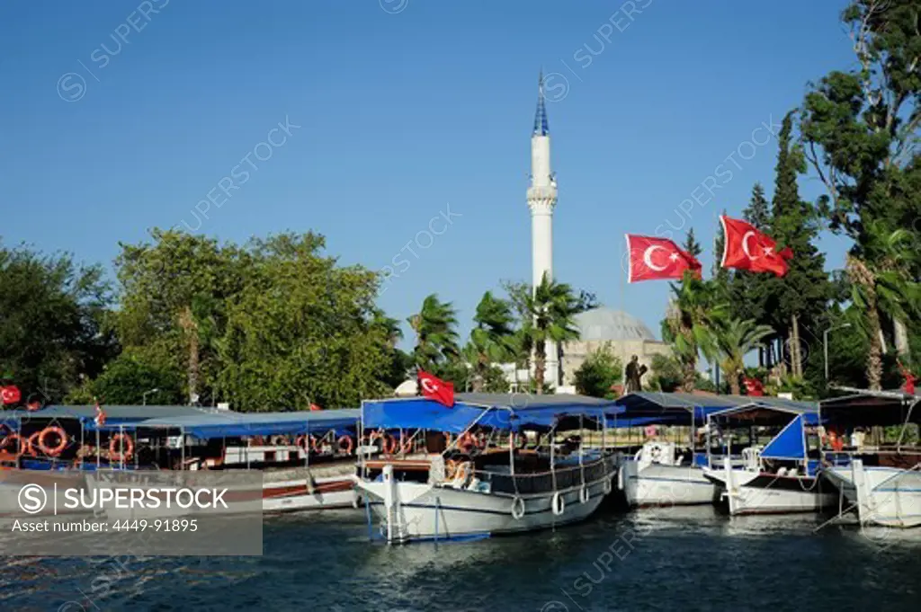 Excursion boats on the river near a mosque in Dalyan, district of Mugla, Mediterranean, Turkey
