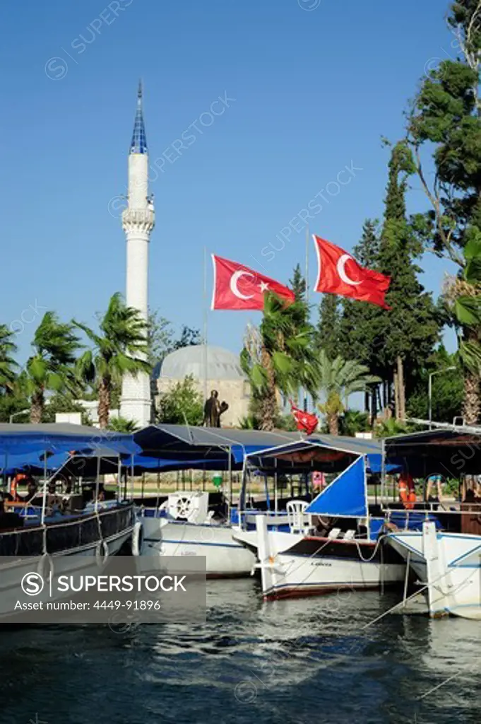 Excursion boats on the river near a mosque in Dalyan, district of Mugla, Mediterranean, Turkey