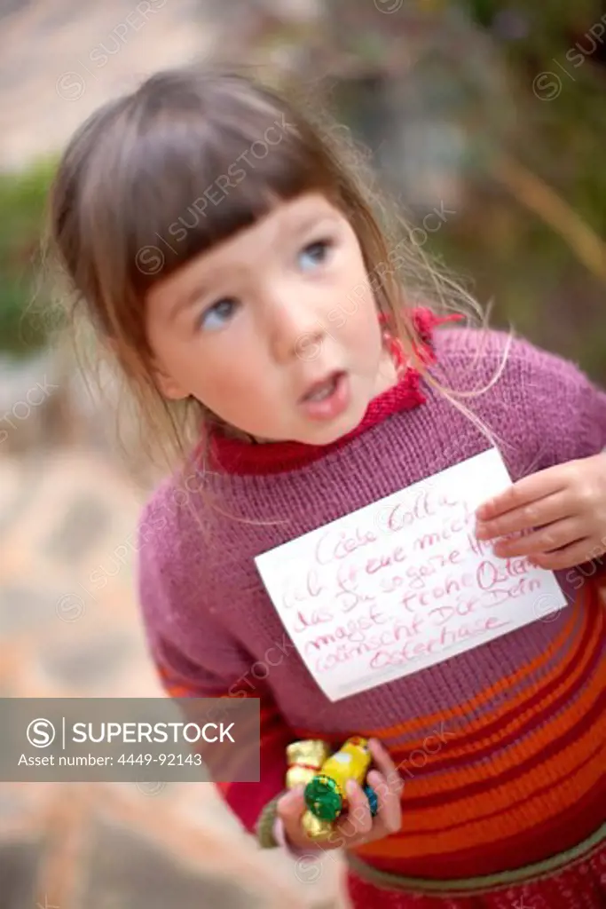 Girl with sweets and a letter, Santanyi, Majorca, Balearic Islands, Spain