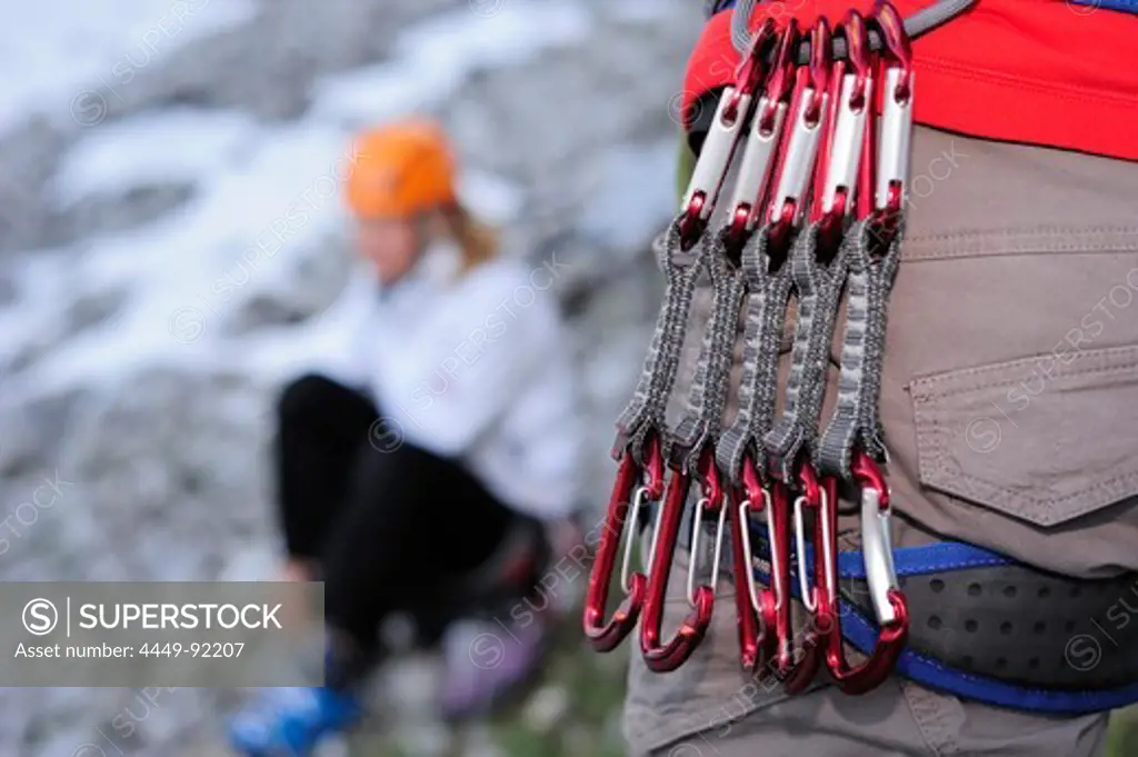 Runners hanging from climbing harness, Multerkarwand, Treffauer, Wegscheidalm, Wilder Kaiser, Kaiser Mountain Range, Tyrol, Austria