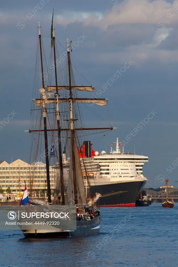 Sailing ship in front of cruise ship Queen Mary 2 at harbour, Hamburg Cruise Center Hafen City, Hamburg, Germany, Europe