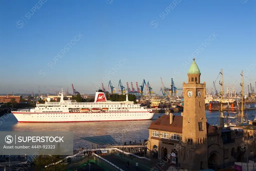 Cruise ship MS Deutschland entering port at the tower of St. Pauli Landungsbruecken, Hamburg, Germany, Europe