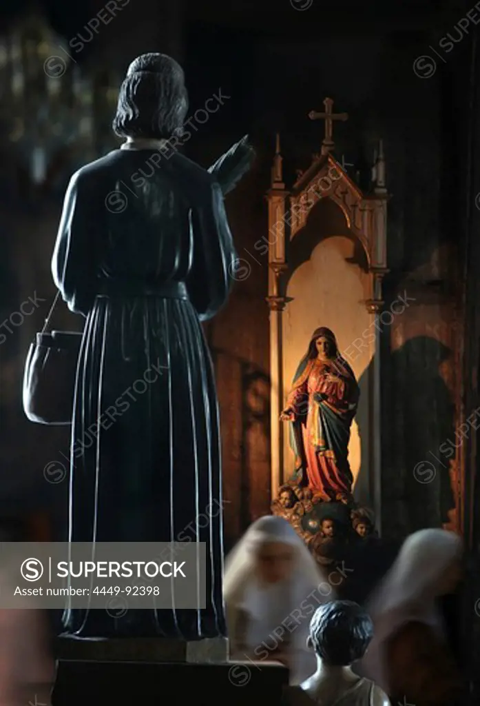 Nuns and statues in Basilica de San Sebastian, the only all steel church in Asia, Manila, Philippines, Asia